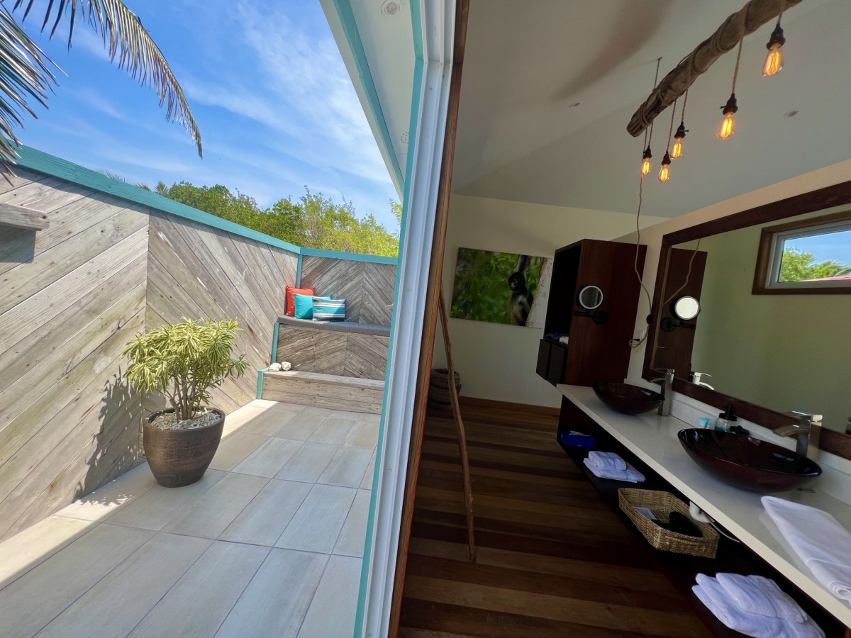 Inside bathroom with sliding doors to outside shower room